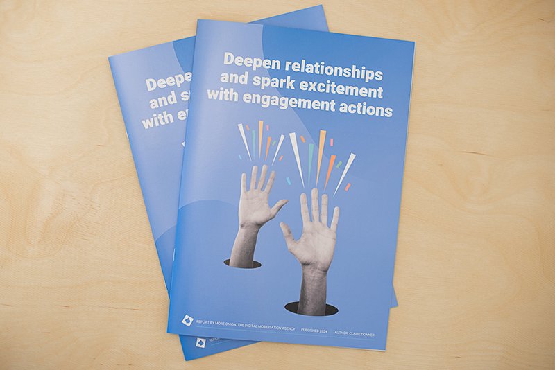 Image of the cover of printed reports showing two hands on a blue background