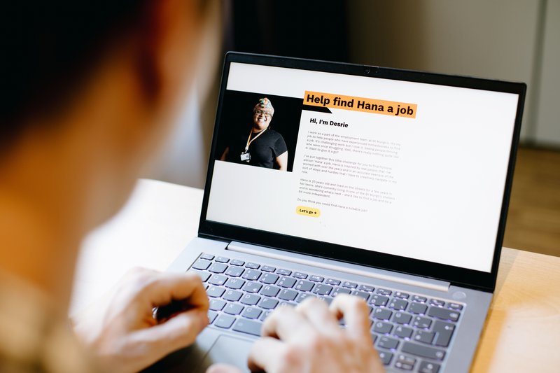 Over the shoulder view of someone reading copy on their laptop