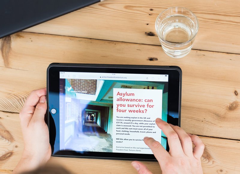 Tablet on a wooden table showing an online action page with outstanding conversion rates